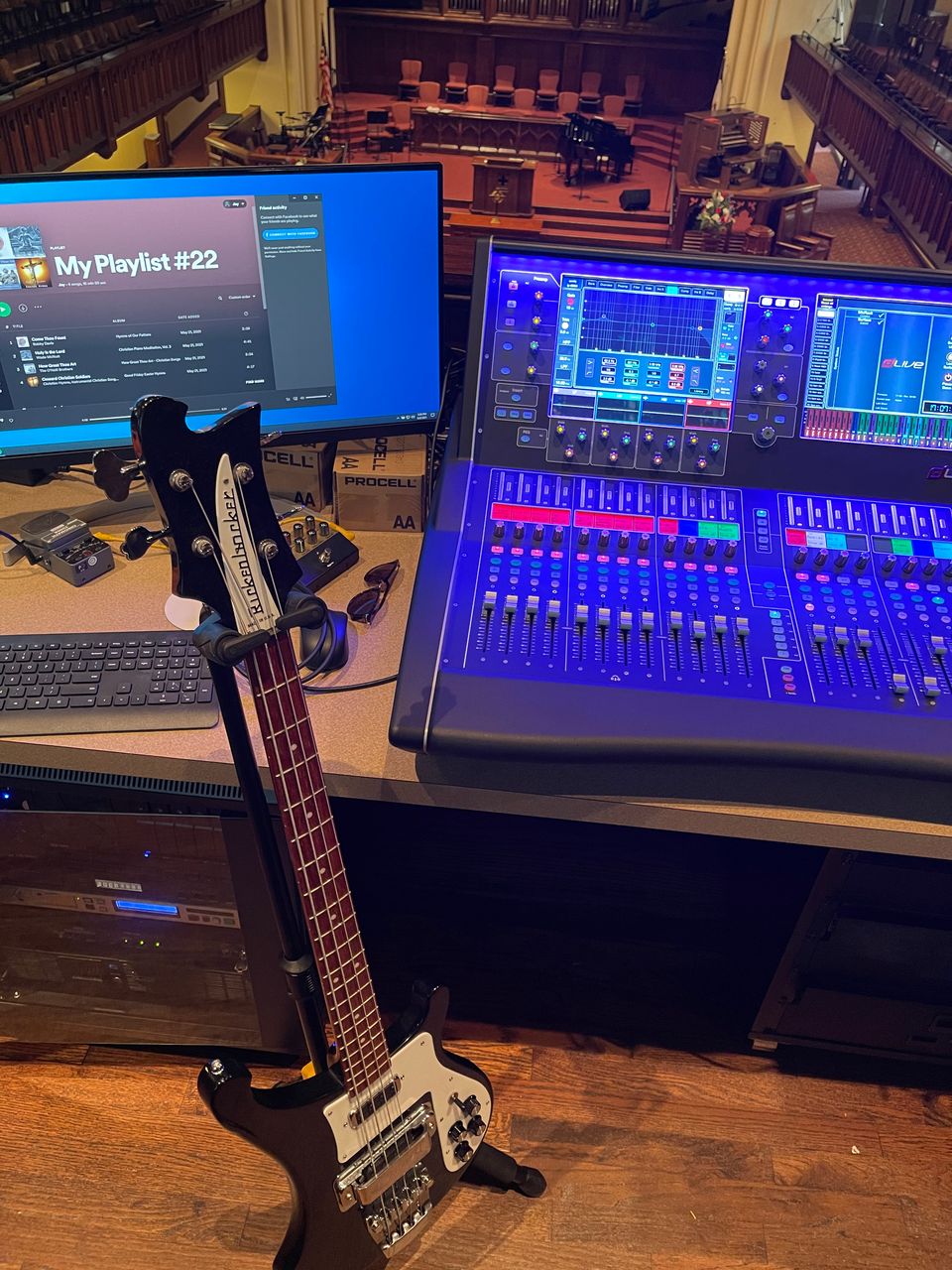 Allen & Heath dLive console at FPCBR front of house with a Rickenbacker bass, monitor showing the worship team's playlist, and rack-mounted gear.