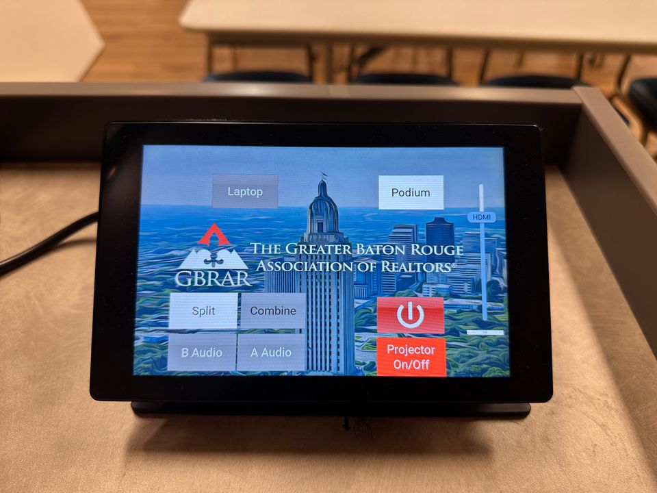 The Q-SYS TSC-70 touchscreen that combines and splits the two classrooms