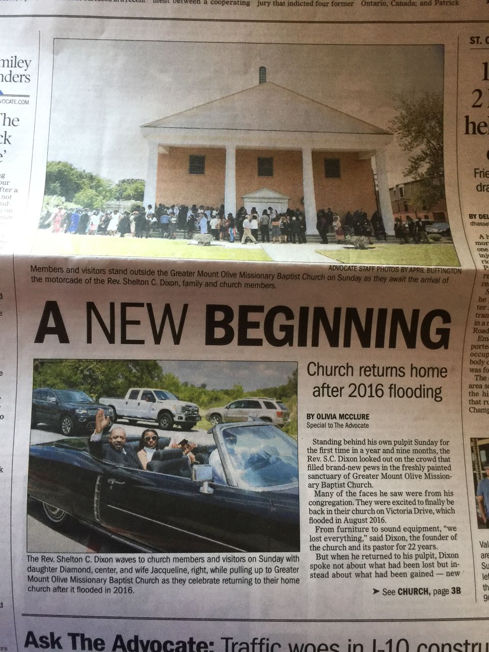 Article from The Advocate "A NEW BEGINNING: Church returns home after 2016 flooding" with photos of Reverend Shelton C. Dixon waving from a car.