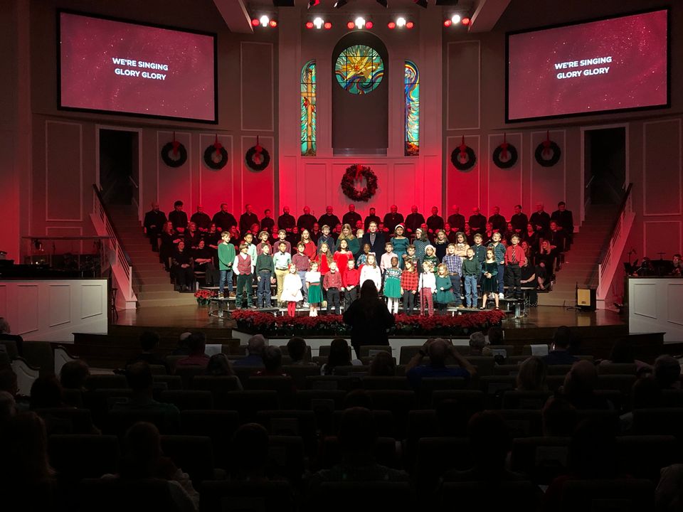 Jefferson Baptist Christmas program in service — choir, band, and congregation all active under the dual side screens.